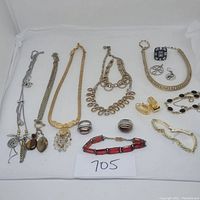 Overall view of the lot showing various jewelry pieces including rings, necklaces, bracelets, and pendants.