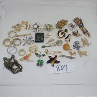 Full lot of over 30 assorted pins including animal shapes, floral motifs, hearts, letters, and abstract designs in various metals and decorations.