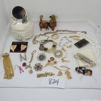 Full lot overview showing various jewelry pieces and porcelain trinket box with mirror.