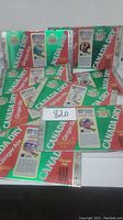 Photo showing flat rectangular Canada Dry ginger ale tins featuring various NFL team logos and information including jerseys and helmets. Tins have visible wear and rust spots.