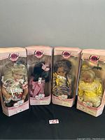 Four Lissi dolls in original boxes with pink and clear window packaging, dolls posed with various colorful outfits.