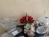 Wide view of lot with Capidomonte floral basket, cut glass bowls, bell, shell dish, and rectangular cut crystal dish