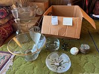 Overview of punch bowl, decanter with stopper, several glass bowls, chip and dip dish, decorative boxes, and box for additional items.