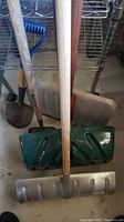 Photo showing three shovels side-by-side with different scoop blades and wooden handles