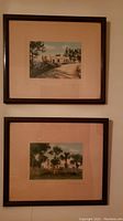 Two framed Bermuda artwork prints, both signed, show outdoor scenery in wood frames with light mats.