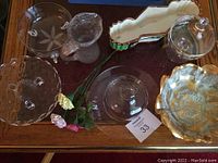 Top view of glassware pieces along with the gold porcelain dish on table