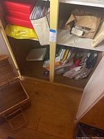 Photo showing inside cabinet shelves 3 and 4 with red and brown gift boxes, gift bags and empty boxes stored inside.