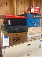 Side and top view of binders stacked on boxes including Tyvek envelopes and Xerox paper box.