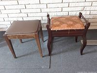 Photo of two stools side by side on a carpeted floor against a white brick wall, showing the overall condition and design.