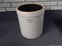 Side view of the entire crock showing the beige exterior and overall shape