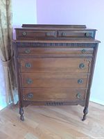 Full front view of antique wooden dresser showing entire piece and drawer configuration.