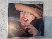 Front cover of The Cars LP record featuring woman behind steering wheel.