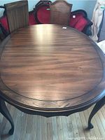 Top view of rectangular wooden dining table with rounded edges and wood grain pattern.