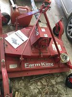 Overall view of red Farm King Y450R finishing mower deck, gearbox and frame