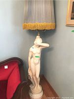Full photo of the lamp showing nude female figure sculpture on marble base with pleated shade and candelabra arms