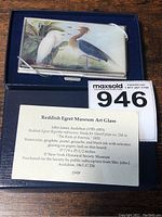 Front view of the art glass card case in its original blue velvet-lined box with the descriptive museum card and a MaxSold lot number.