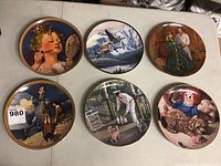 Six collector plates arranged on table, showing full artwork and design