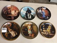 Photo showing all six 8.5-inch collector plates arranged in two rows of three, displaying diverse vintage-style artwork scenes.