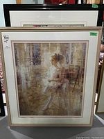 Pair of framed prints showing the ballerina girl, one with white frame and one with black frame, displayed together.