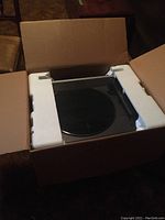 Akai turntable inside original styrofoam and cardboard box.