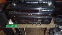 Photo of Marantz CC-48 CD player stacked on top of Marantz SR-48MK receiver on a small wooden table, showing their front panels and control buttons.