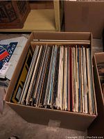 Cardboard box filled with assorted vinyl LP record albums