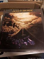 Photo of Jackson Browne vinyl album 'Running on Empty' with cover showing a road and drum kit.