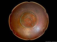 Top-down view of the handcrafted copper bowl showing the scalloped edges and hammered texture inside.