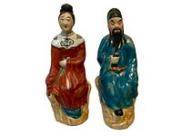 Pair of porcelain Famille Rose figurines on white background showing front view