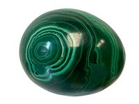 Top view of polished malachite showing concentric green banding and shiny surface reflection.