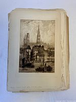 Stack of antique etchings showing top etching titled 'Rouen' after R.P. Bonington, visible wear and uneven edges