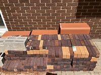 Stacks of red and buff rectangular paving bricks