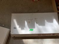 White Car Case exterior with wear marks and label.
