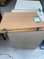 Closed hinged wooden case on top of cabinet