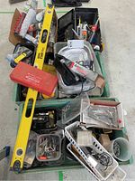 Photo of entire lot showing toolbox, level, tap and die set case, and various containers with tools and supplies.