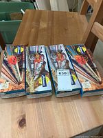 Four sealed boxes of Athearn HO scale model train cars on a wooden table, showing the packaging and artwork.