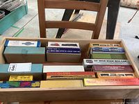 Wooden drawer filled with boxed HO scale model train cars and kits from various manufacturers including Funaro & Camerlengo and Globe. Boxes have labels describing contents like boxcars and metal wheels.