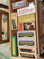 Wooden drawer with several boxed HO scale model train cars from various manufacturers: Tyco, Accurail, Empire Builder Series, and Canadian Northern.