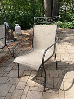 Single metal-frame sling patio chair showing seat/back and fabric pattern