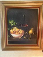 Frontal view of the framed still life oil painting showing fruit, decanter and glass