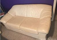 Off white contemporary love seat shown from front angle, seating cushions and armrests visible.