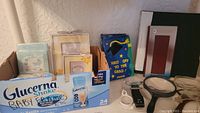 Various picture frames, photo album, magnifiers, and Rolodex holder arranged on table