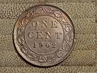 Reverse side of the 1902 Canadian one cent coin showing denomination and year with maple leaf wreath.