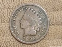 Front (obverse) of 1895 USA Indian Head one cent coin showing Indian Head with feathered headdress and date 1895.