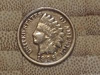 Obverse side of 1896 Indian Head One Cent coin showing Lady Liberty with Native American headdress and date 1896.