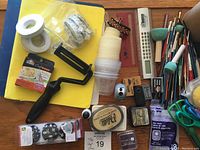 Image showing assortment of brushes, glue sticks, stamping supplies, tape rolls, tools, and other small craft items to detail contents of the lot.