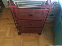 Red IKEA metal 3-drawer storage unit on wheels