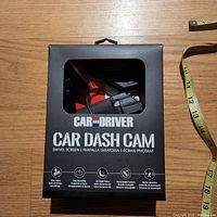 Front of the Car and Driver Car Dash Cam box showing branding, swivel screen feature, and icons for time stamp, loop recording, LED night vision, rechargeable battery, and motion detection.