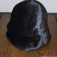 Front view of the black mink fur hat showing glossy fur texture and shape