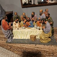 Full front view of the Last Supper figurine displaying all 13 detailed figures around the table with pottery and bread